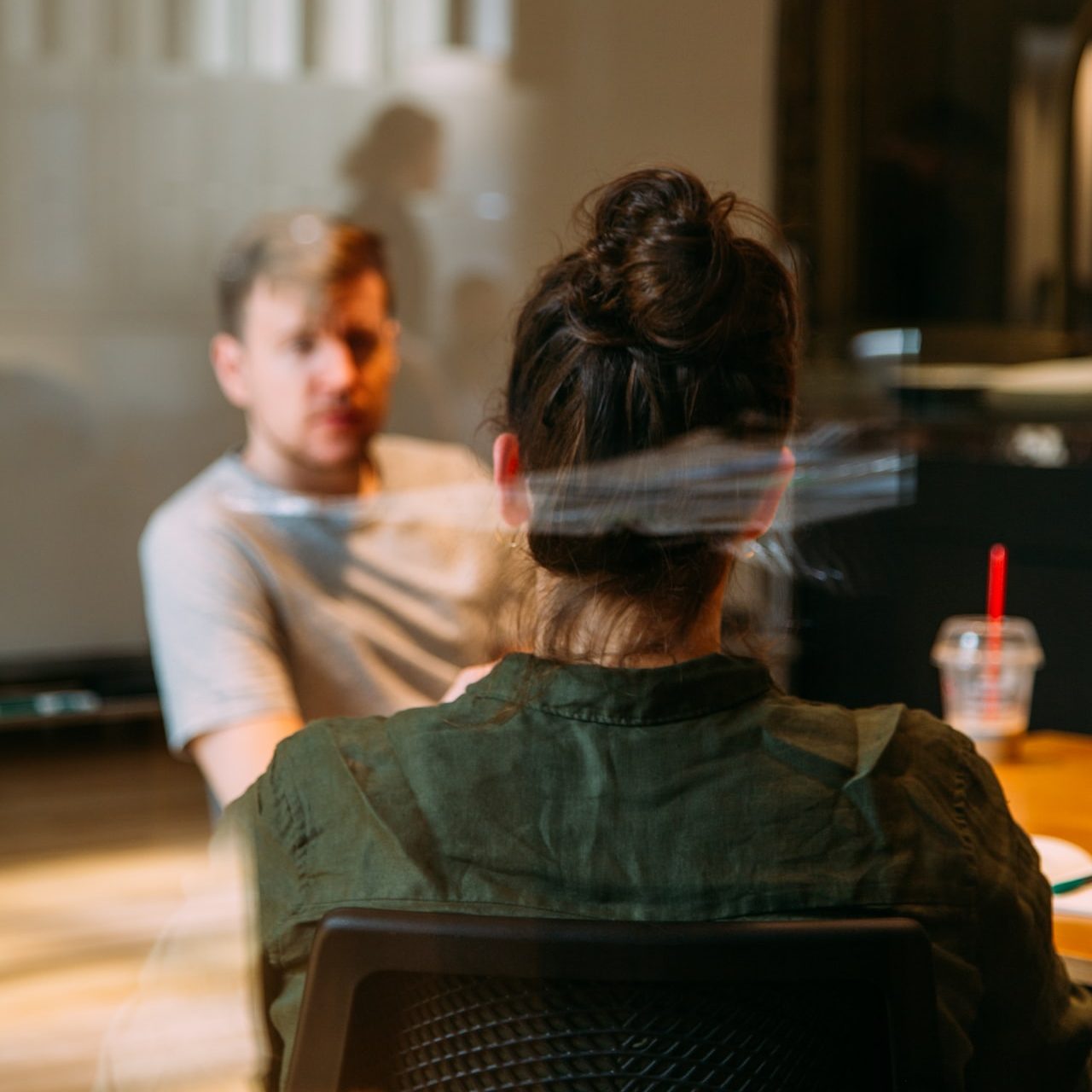 person sitting in a chair in front of a man