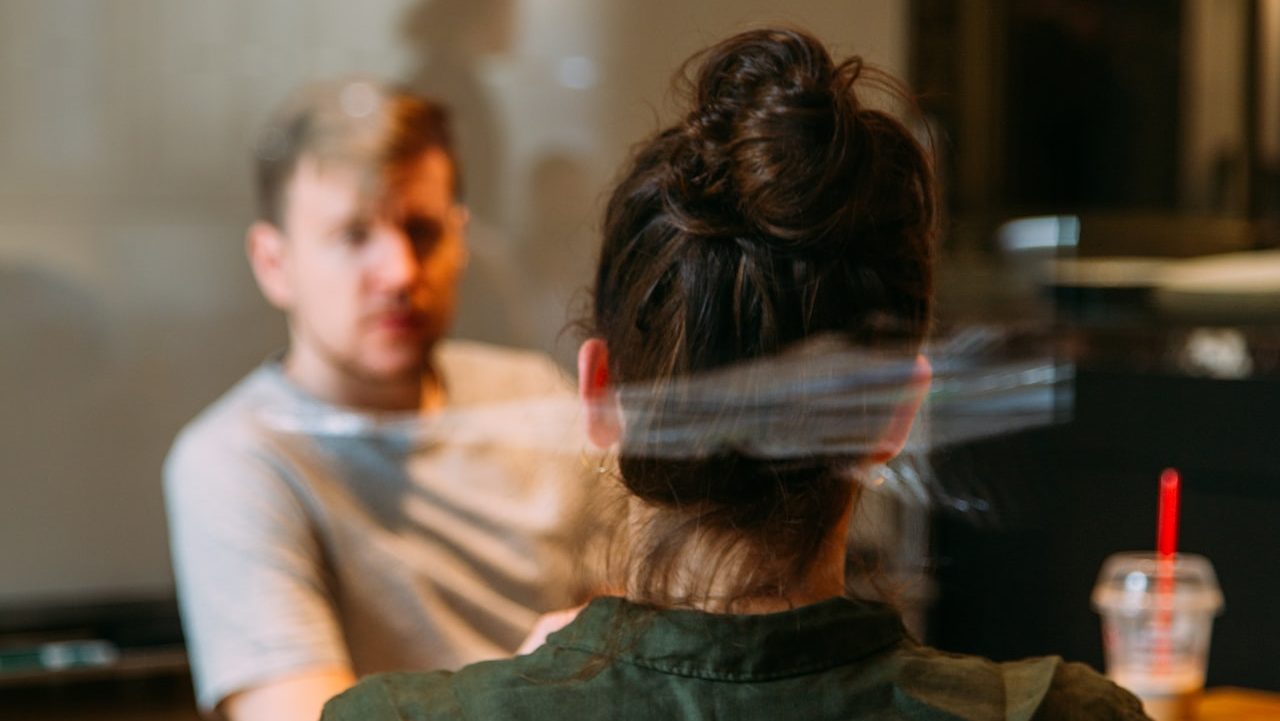 person sitting in a chair in front of a man